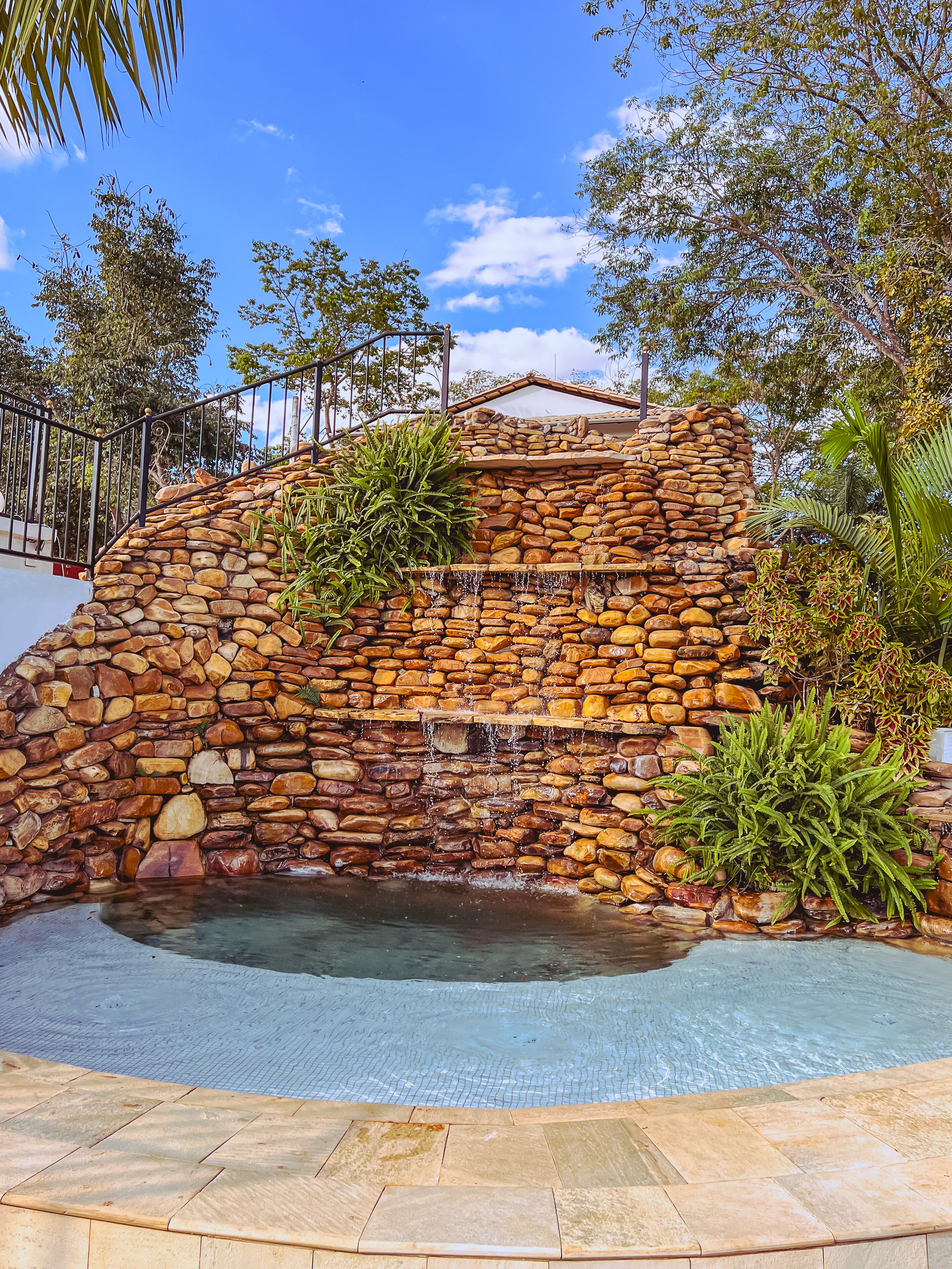 Outdoor pool, a waterfall pool, pool loungers