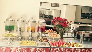 A buffet setup with various food items and drink dispensers. - Full Moon Da Lat Hotel (Cam Ly - Da Lat)