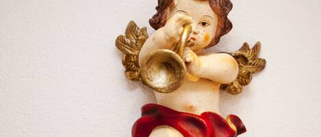 A figurine of a child playing a trumpet.