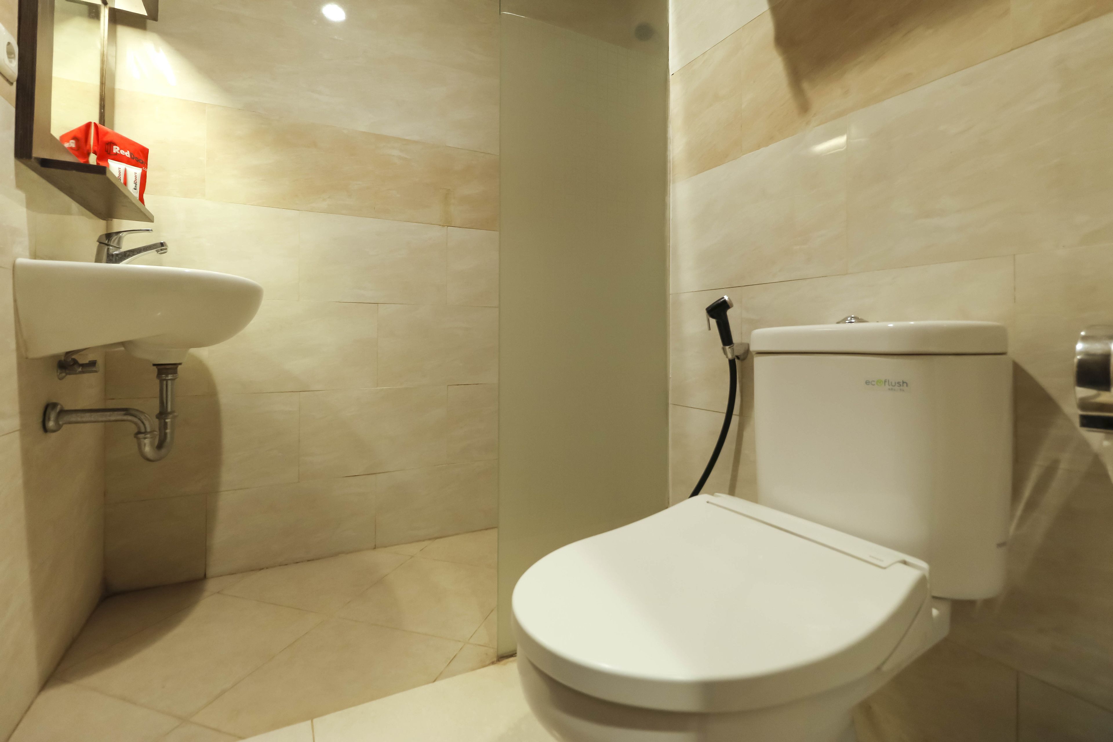 A bathroom with a white sink, toilet, and shower.