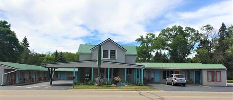 A motel with a central building and two smaller structures.