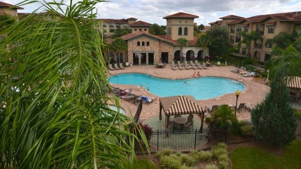A swimming pool surrounded by a courtyard with lounge chairs and a gazebo. - 431BVD (Davenport)