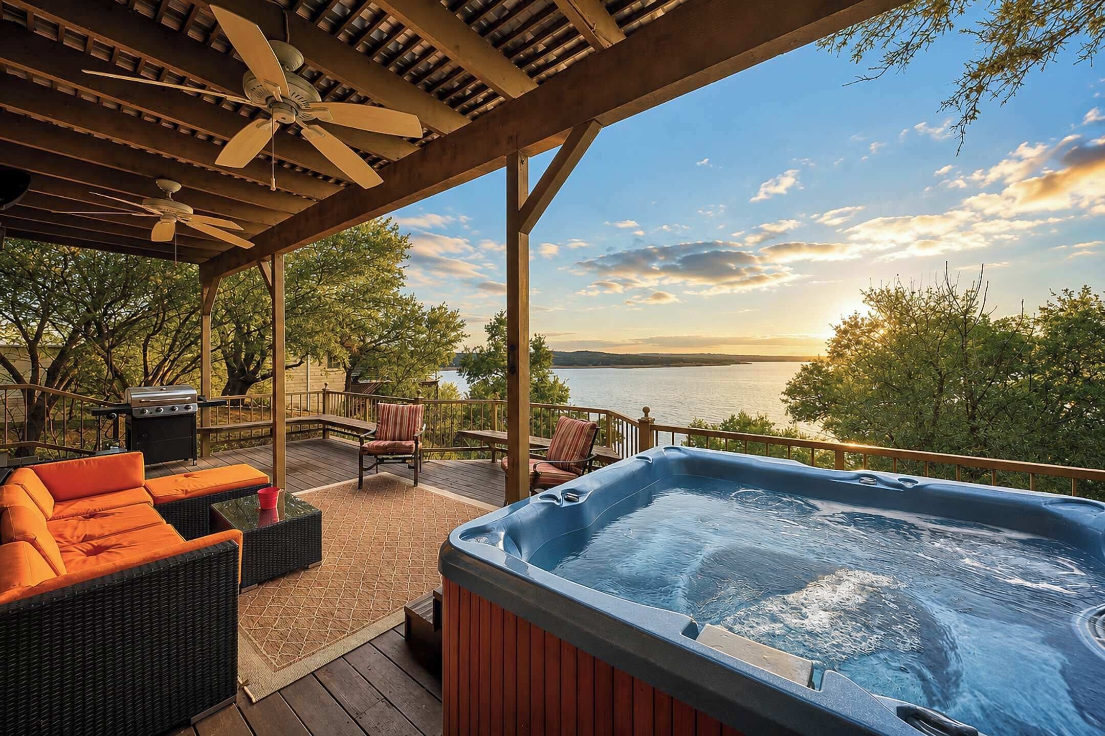A hot tub under a wooden pergola with a view of a lake and trees.