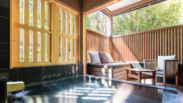 A spa area with a hot tub, wooden seating, and large windows. - Hakone Suishoen (Hakone)