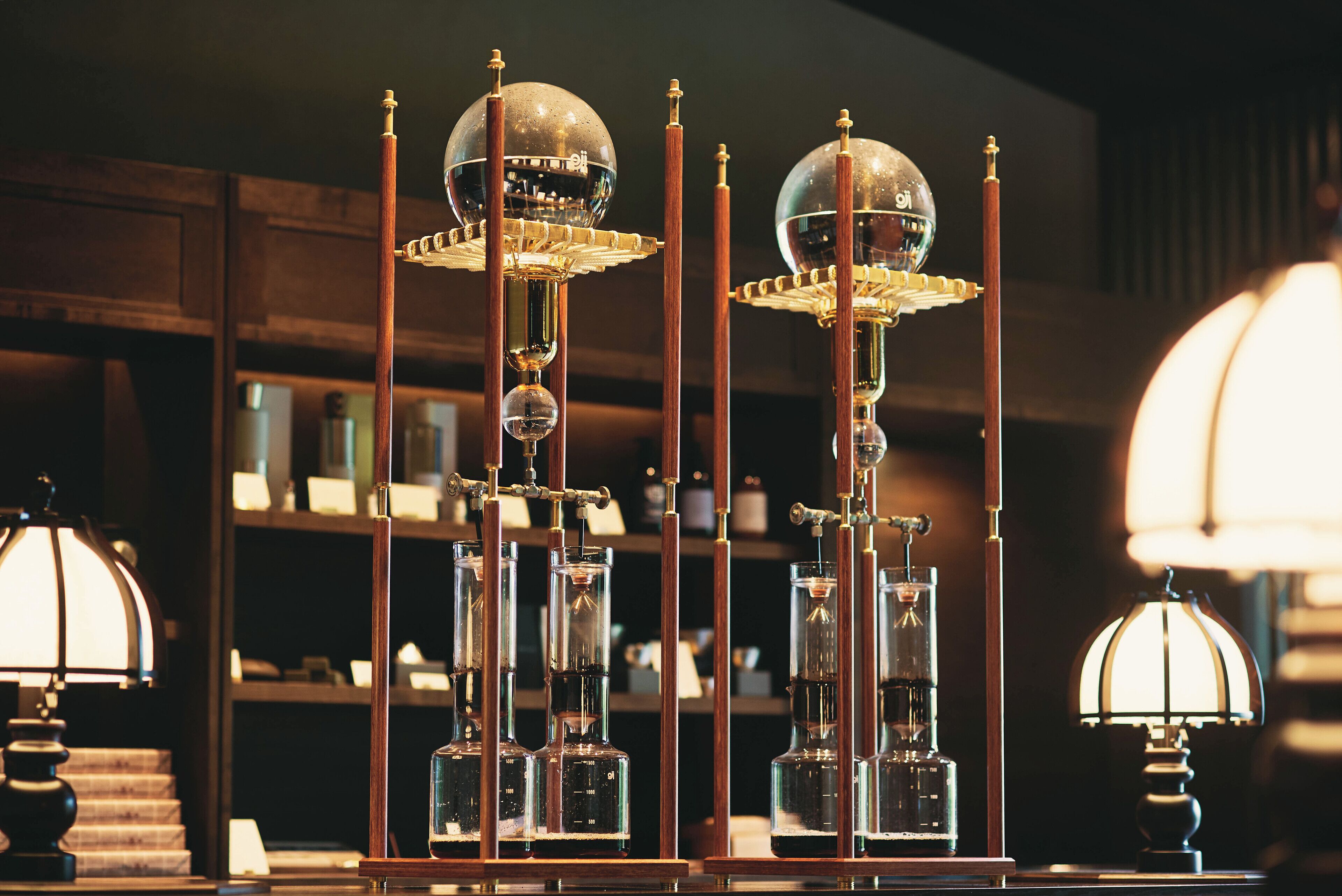 A room with a wooden cabinet, a lamp, and a shelf with various items.