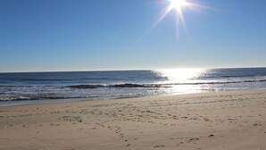 A beach with footprints in the sand and the ocean in the background. - ADAGIO#207 BEAUTIFUL 3 BED/3 BATH OCEAN BLOCK CONDO W/INDOOR POOL STEPS TO BEACH (Ocean City)