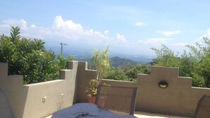 A patio with a view of a hilly landscape. - Luxurious Castle, Infinity Pool And Jaw Dropping Views!  (Atenas)