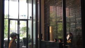 En lobby med receptionsdisk, lysekrone og indtjekningsdisk.