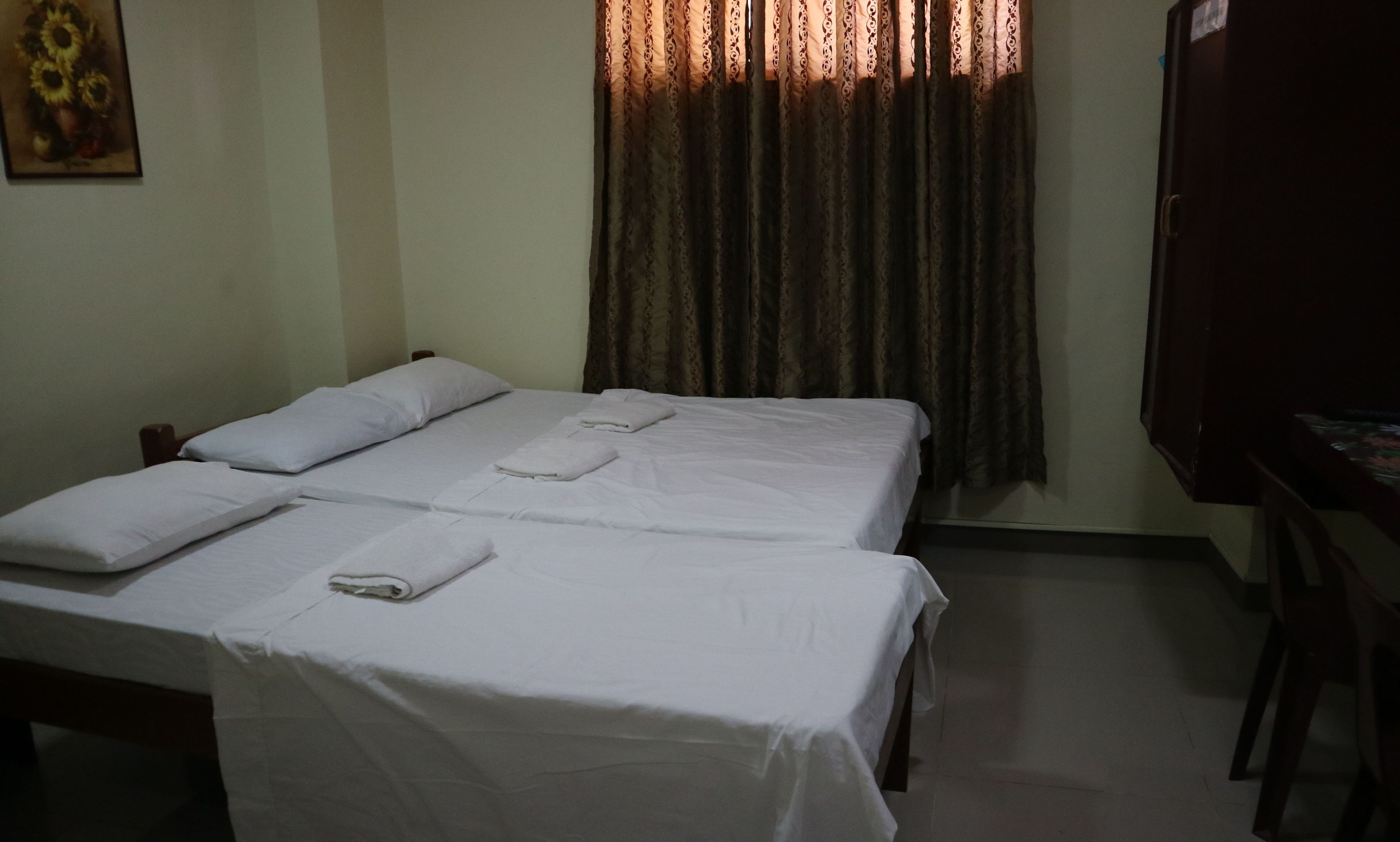 Desk, iron/ironing board, bed sheets