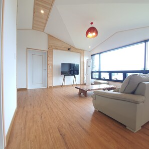 Family Condo, 2 Bedrooms, Non Smoking, Ocean View | Living area | 50-inch flat-screen TV with cable channels, TV, heated floors - On The Stone Pension (Seogwipo)
