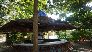 A circular bar area with a thatched roof, surrounded by wooden stools. - Cousin Resort Koh Kho Khao Beach (Takua Pa)