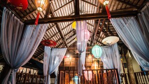 A traditional wooden structure with a high ceiling, featuring hanging lanterns and draped curtains. - Garden Yard Inn Chiangmai (Chiang Mai)