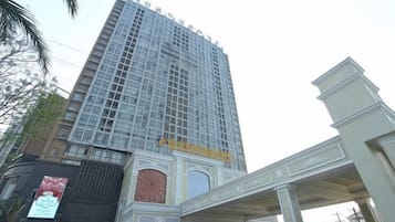 Un hotel alto con una entrada destacada y un letrero grande en la parte superior.