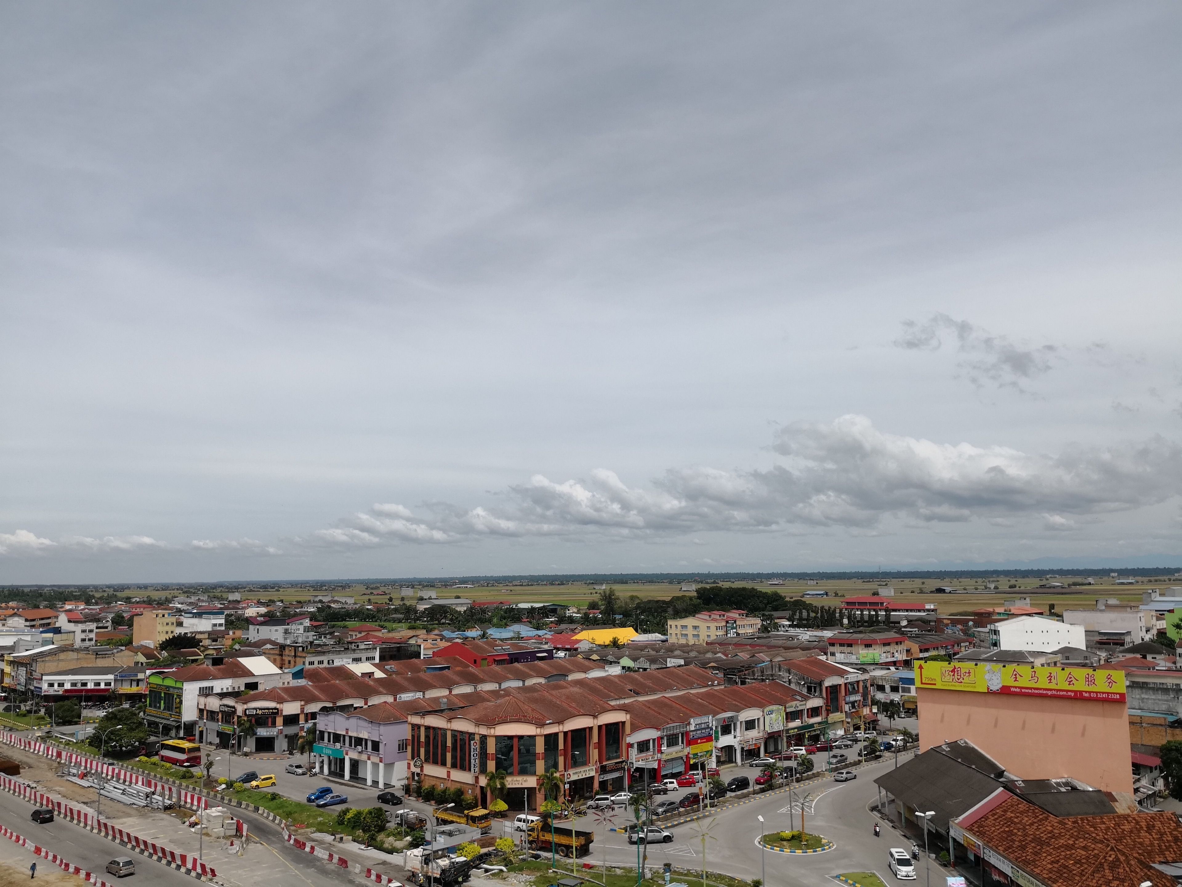 A cityscape with a mix of commercial buildings and residential areas.