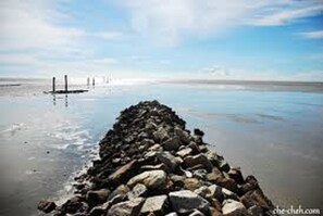 A rocky breakwater extending into calm waters with a clear sky above. - The One Boutique Hotel Sekinchan (Sekinchan)