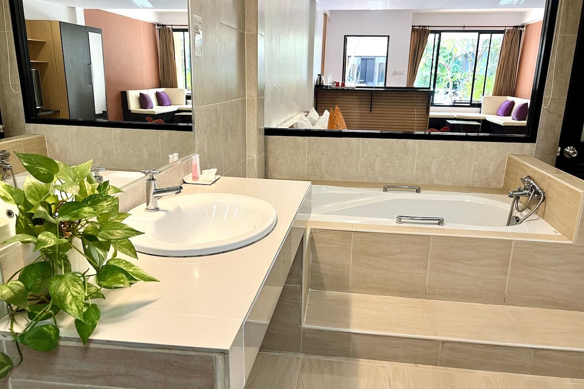 grand deluxe double room with pool view | bathroom | free toiletries, hair dryer, towels