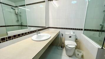 A modern bathroom with a sink, toilet, and shower.