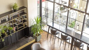 A modern lobby with a reception desk, seating area, and large windows offering a view of the street. - New Balturk Hotel Izmit (Izmit)
