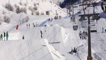 A ski slope with skiers and a ski lift.