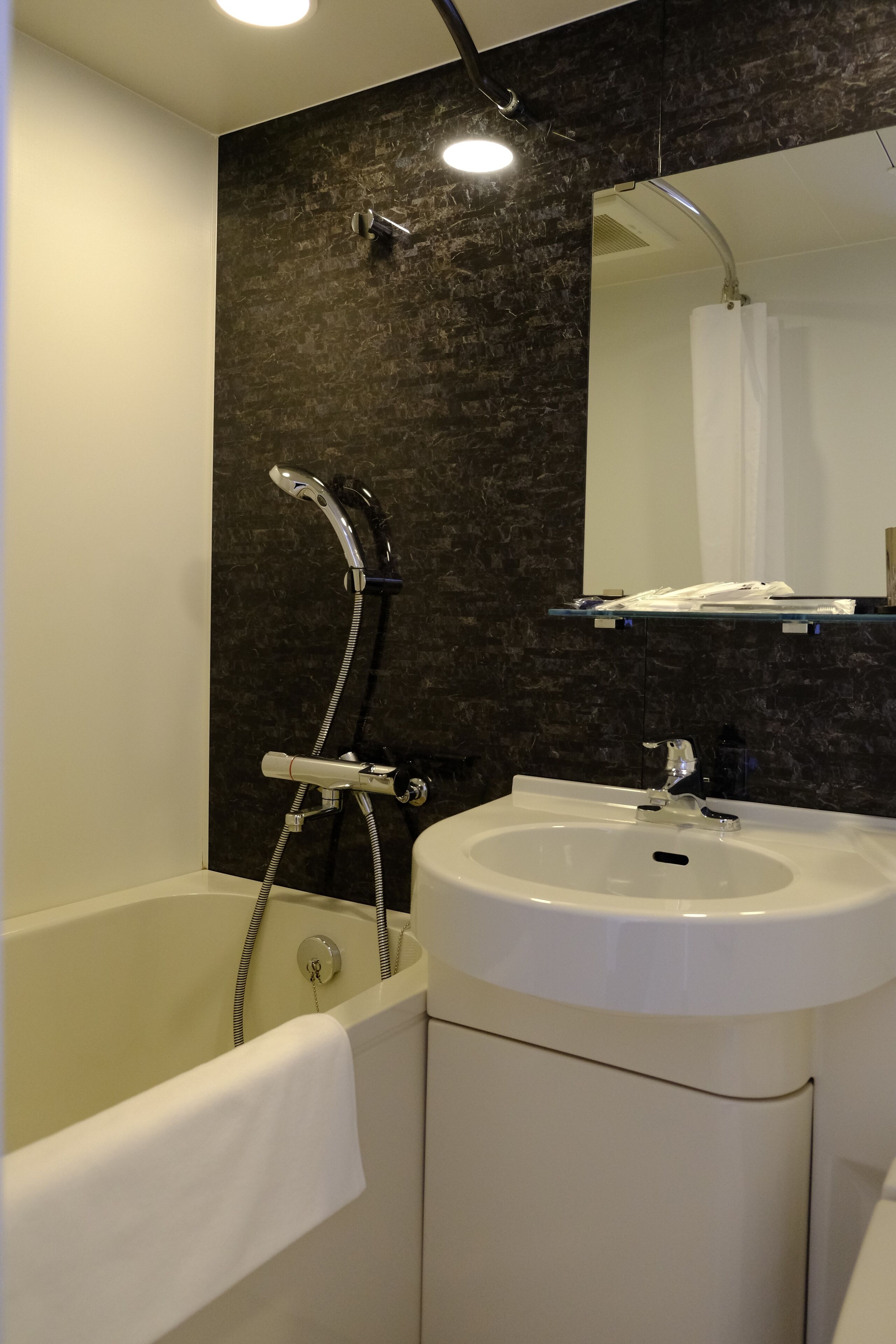 A bathroom with a bathtub, a sink, and a shower.
