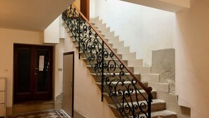 A staircase with ornate metal railings and a checkered floor pattern. - Ca' Giulia (Venice)