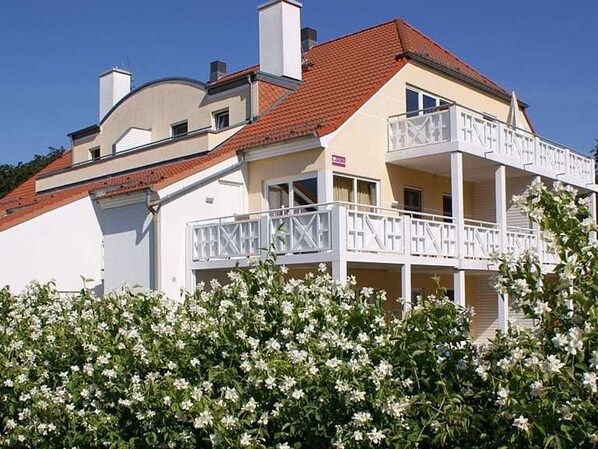 A two-story building with a balcony on the second floor.