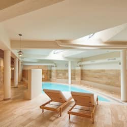 Indoor pool, open 10:00 AM to 10:00 PM, pool loungers