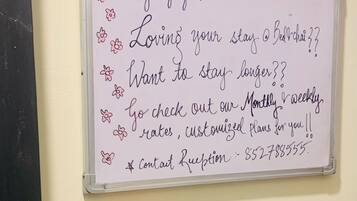 A whiteboard with handwritten text offering customized plans and contact information.
