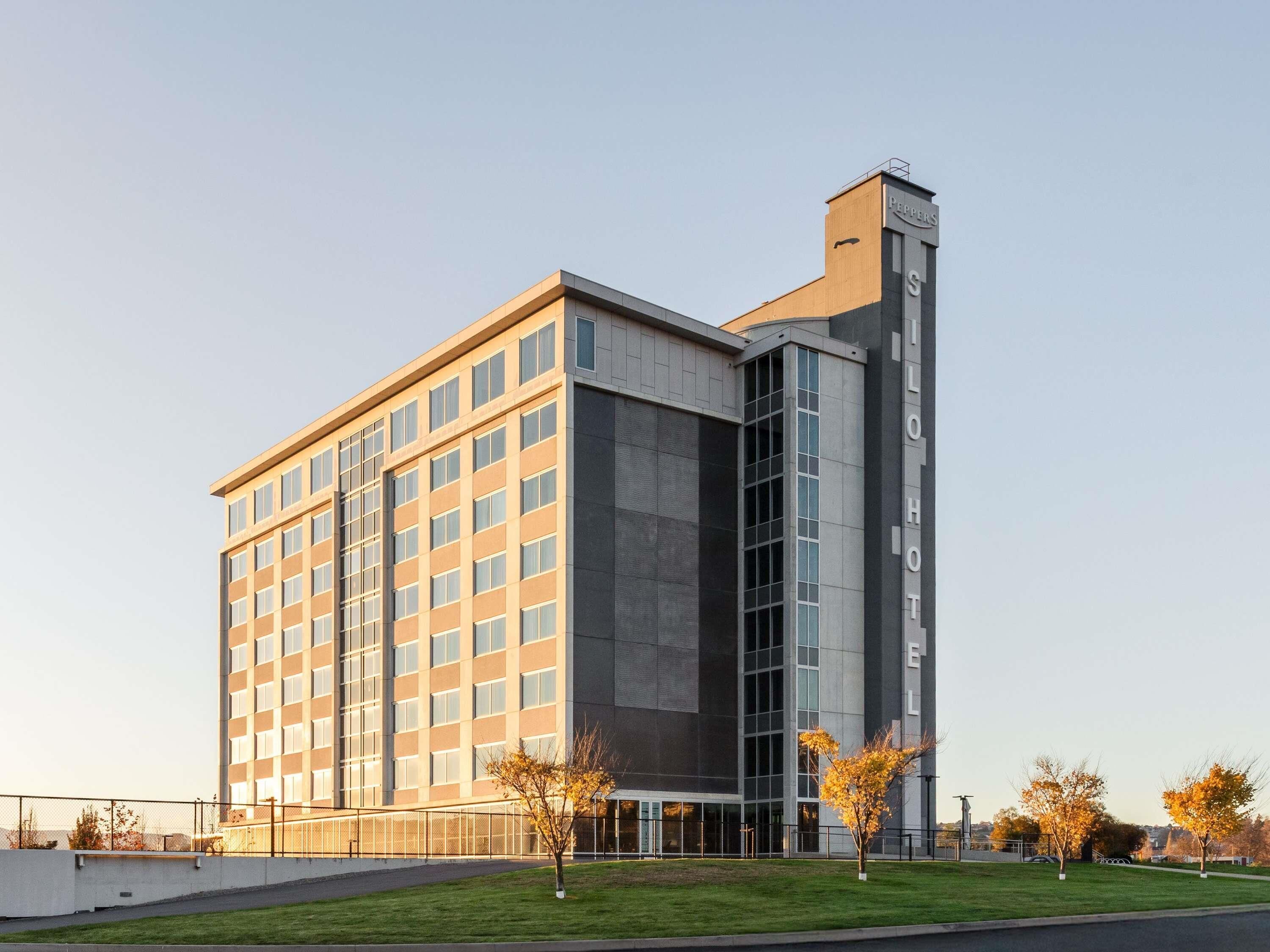 A modern hotel building with a prominent vertical section labeled 'PEPPERS' and 'ILHOT.'