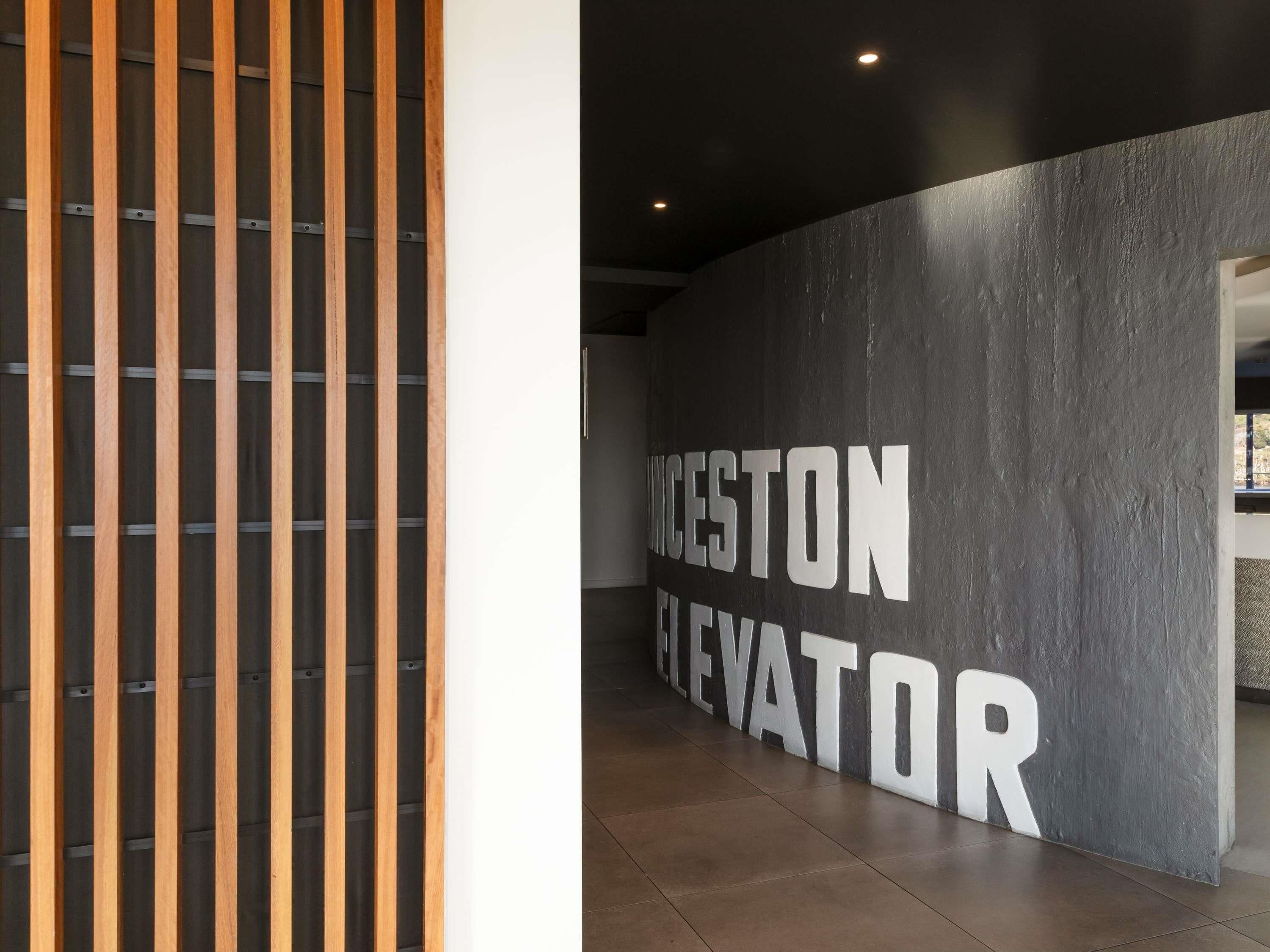 A modern interior with a large wall sign reading 'WILCESTON ELEVATOR.'