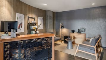 Relax in a well-appointed room with a comfortable seating area, flat-screen TV, and shelving unit.