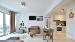 A modern apartment with a living room, dining area, kitchenette, and a balcony. - Alekos Apartments 1 (Athens)