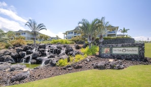 Experience the serene beauty of Na'alehu Keauhou, surrounded by lush greenery and a natural waterfall.