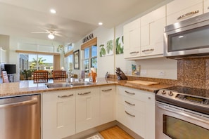 Enjoy cooking in this well-lit kitchen with an oven, stainless steel dishwasher, and sleek cabinetry.