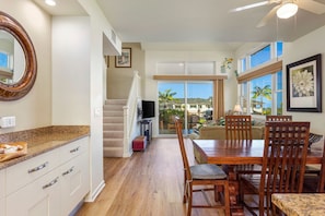 Enjoy a spacious room with a kitchen, dining area, and living space, featuring a sofa and coffee table.