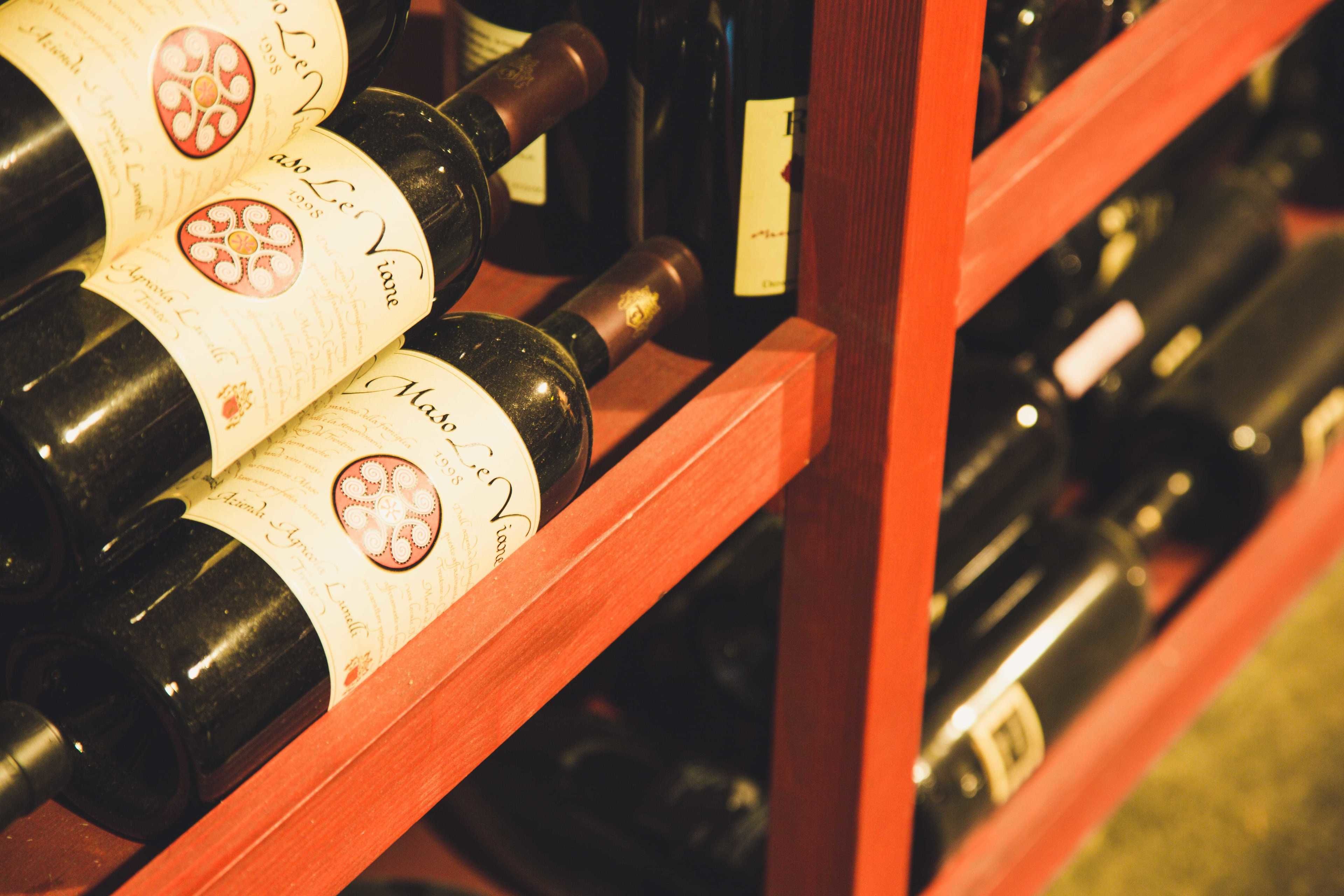 A wooden wine rack holding several bottles of wine.
