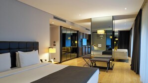 A modern hotel room with a large bed, a desk, a chair, a mirror, and a television. - Metropolitan Hotels Bosphorus (Istanbul)