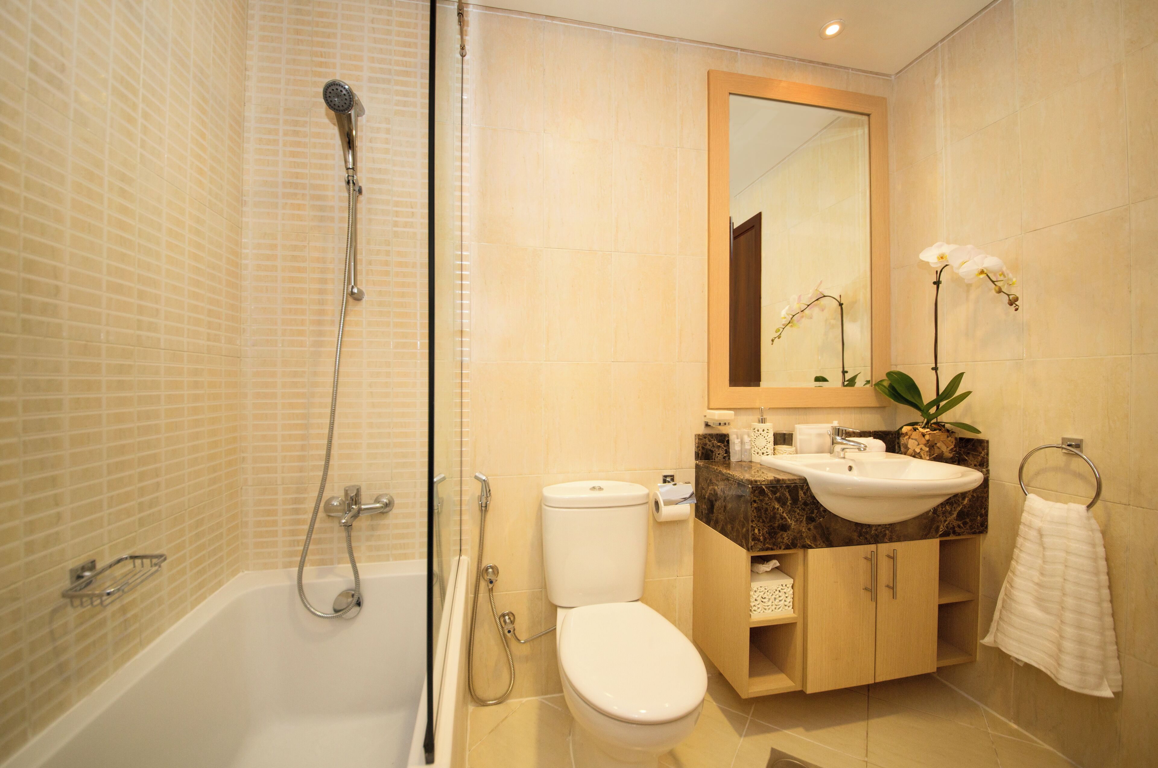 A modern bathroom with a bathtub, toilet, and sink.
