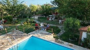 Seasonal outdoor pool, pool umbrellas, pool loungers