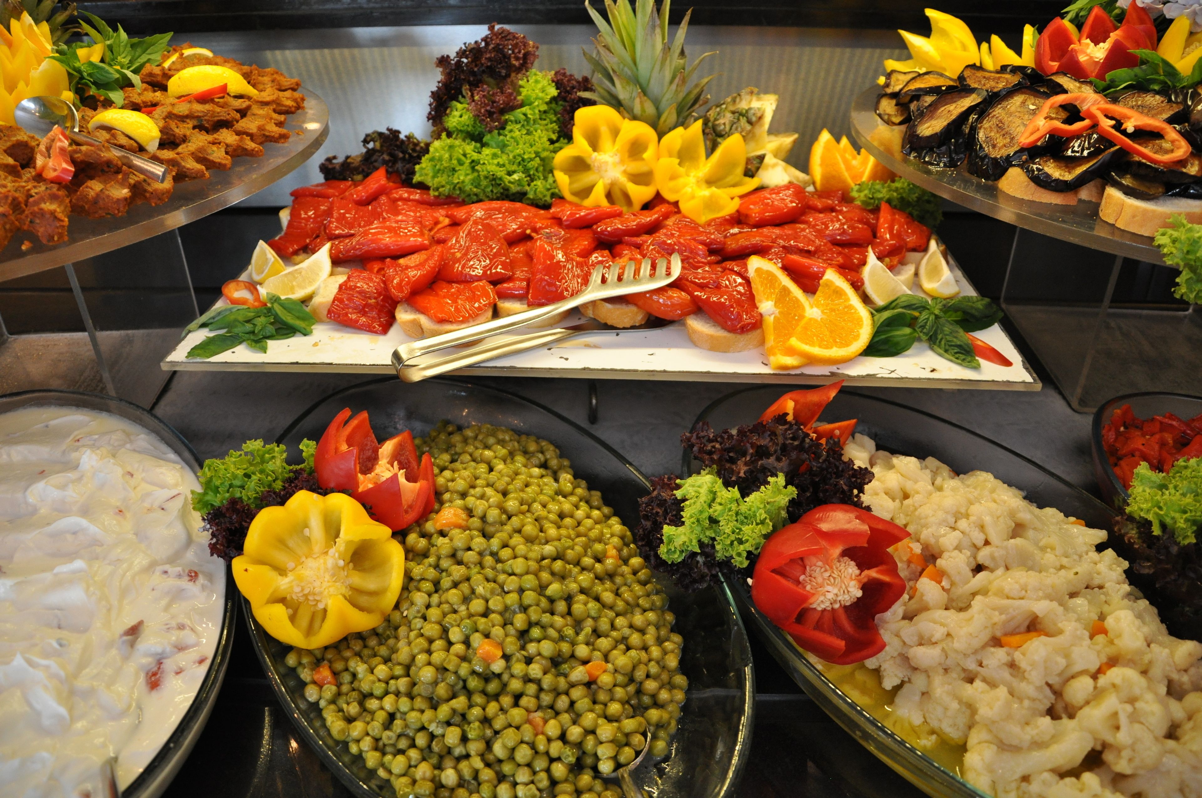 A buffet with various dishes including seafood, vegetables, and salads.