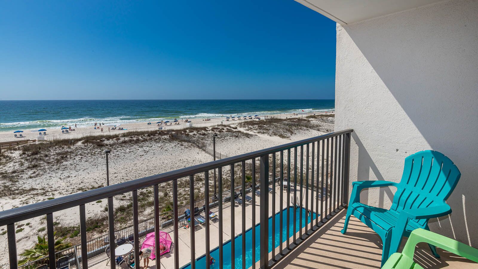 A balcony with a view of a beach and ocean.