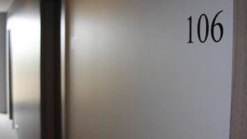 A hallway with a wall displaying the number 106.