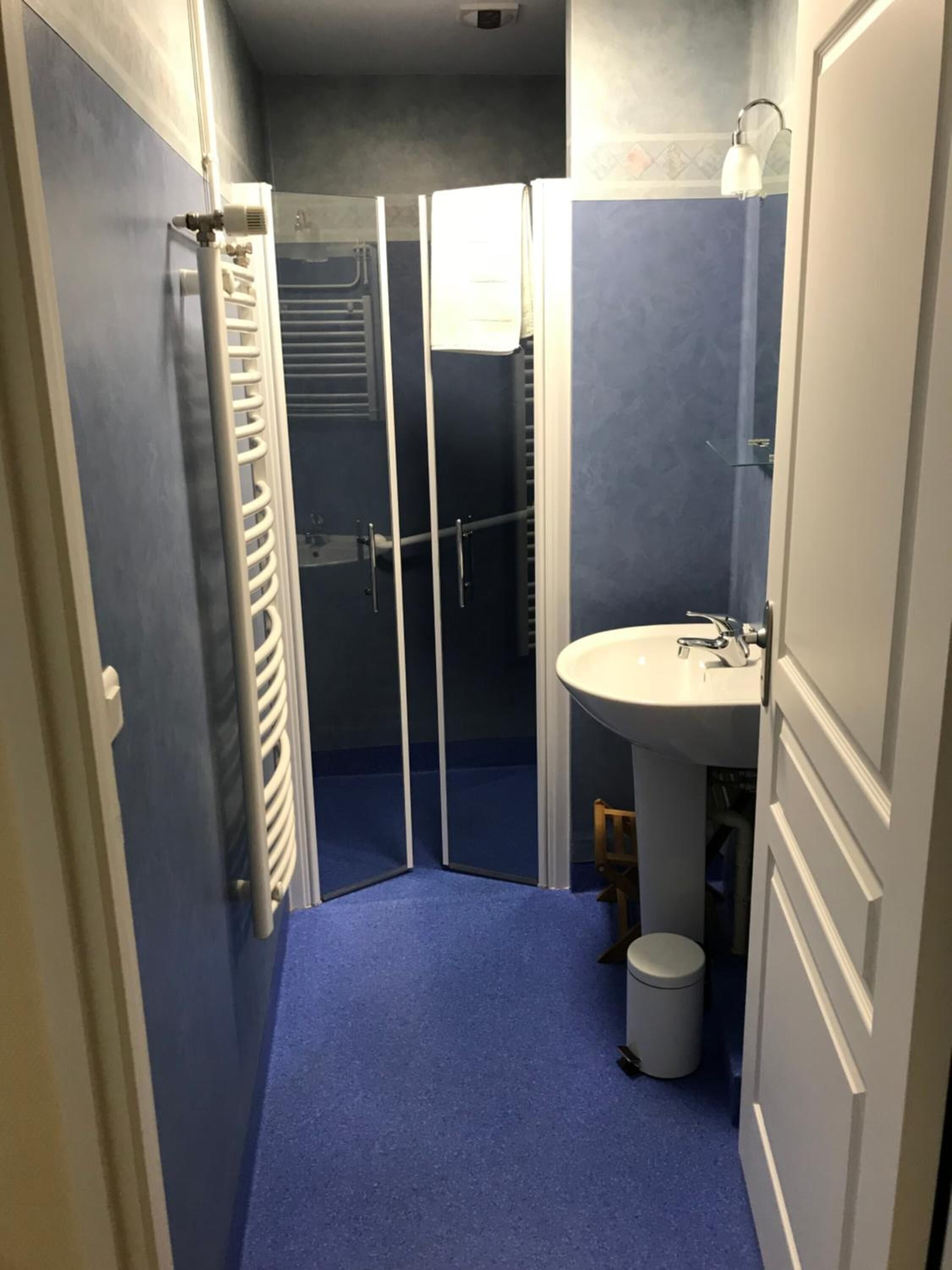 A bathroom with a shower, a sink, and a toilet.