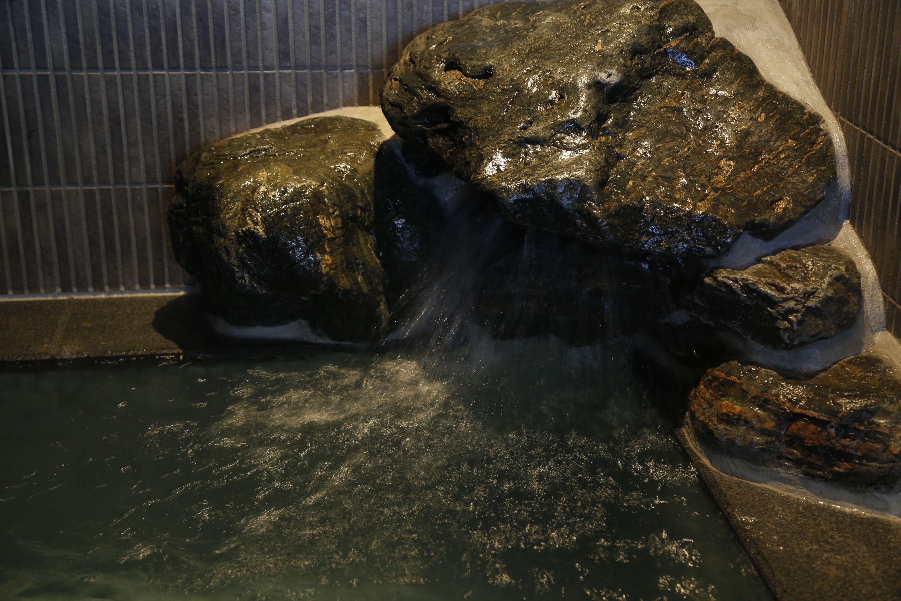 A rock waterfall feature in a spa area.
