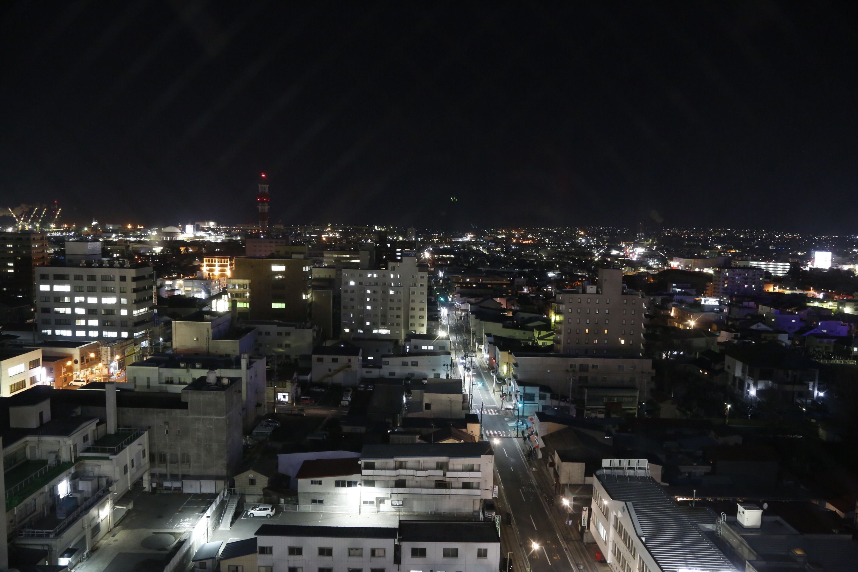A nighttime cityscape with illuminated buildings and streets.
