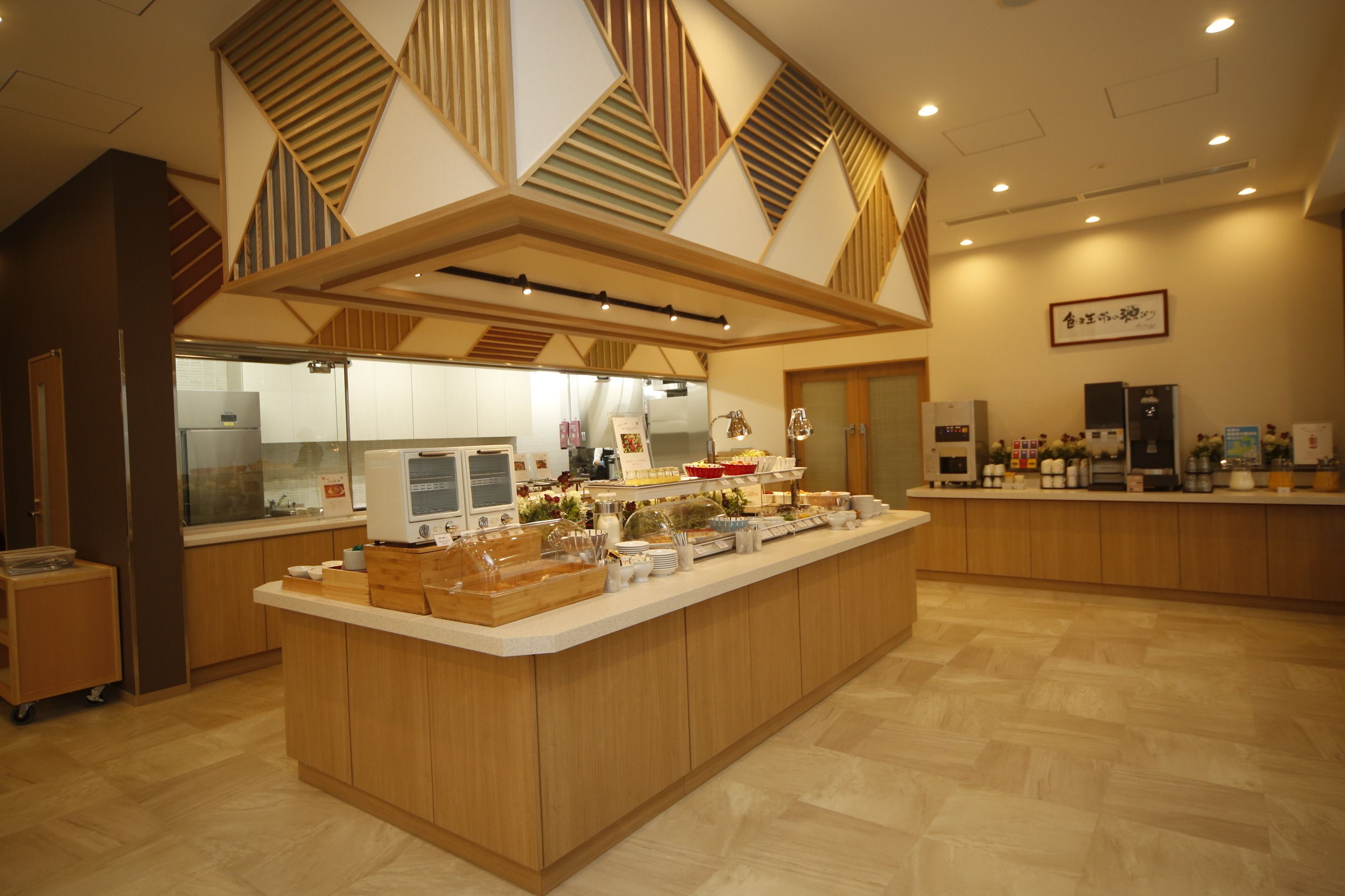 A modern kitchen with a central island, wooden cabinets, and a variety of appliances.