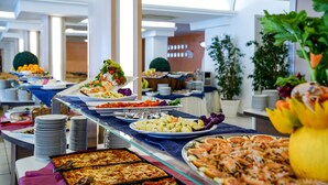 A buffet with various dishes, including salads, fruits, and seafood, in a well-lit indoor setting. - Futura Club Torre Rinalda (Lecce)