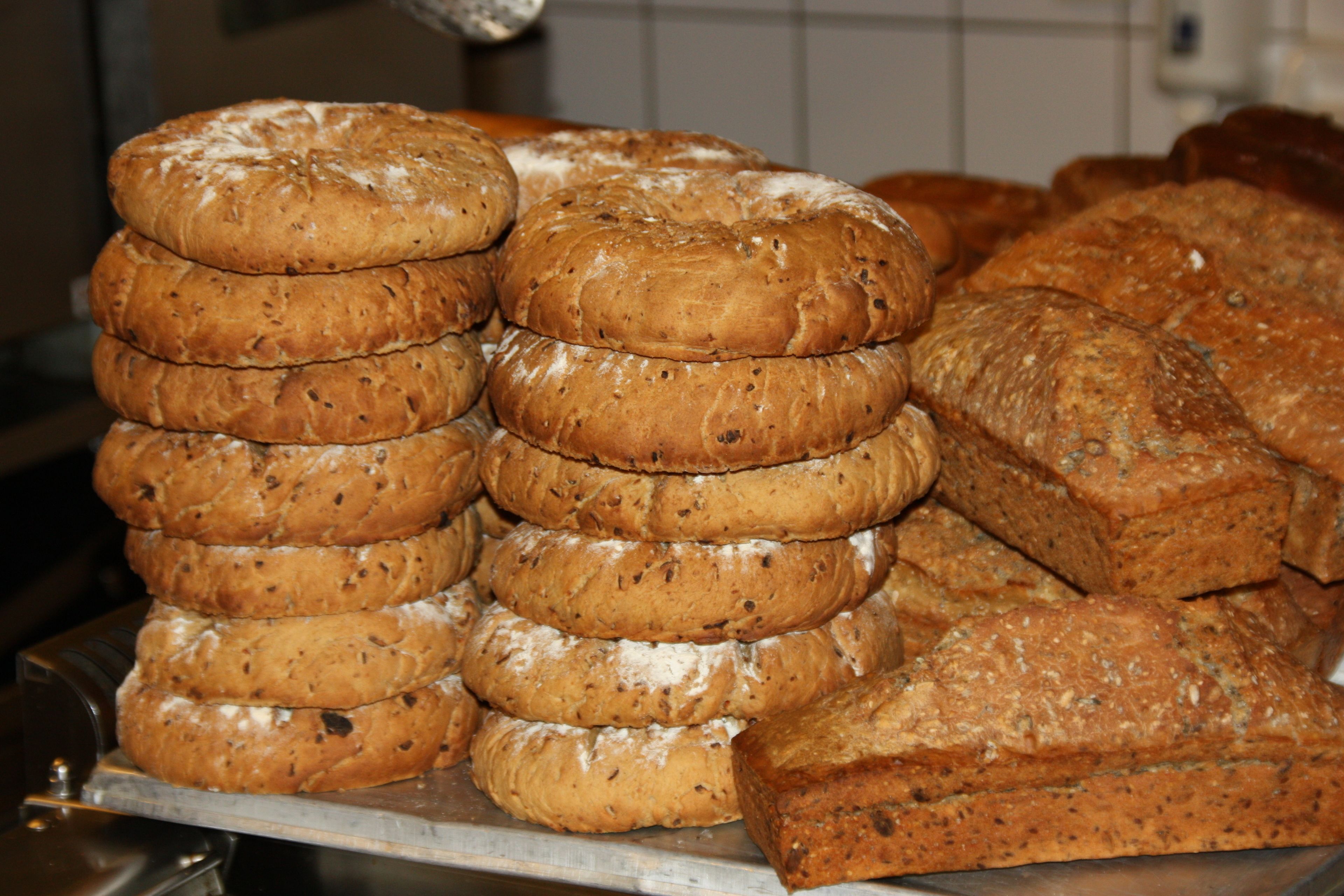 A stack of bread loaves on a metal tray.