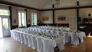 A banquet hall with multiple round tables set for a formal event, featuring white tablecloths and chairs. - Misselhorner Hof (Südheide)