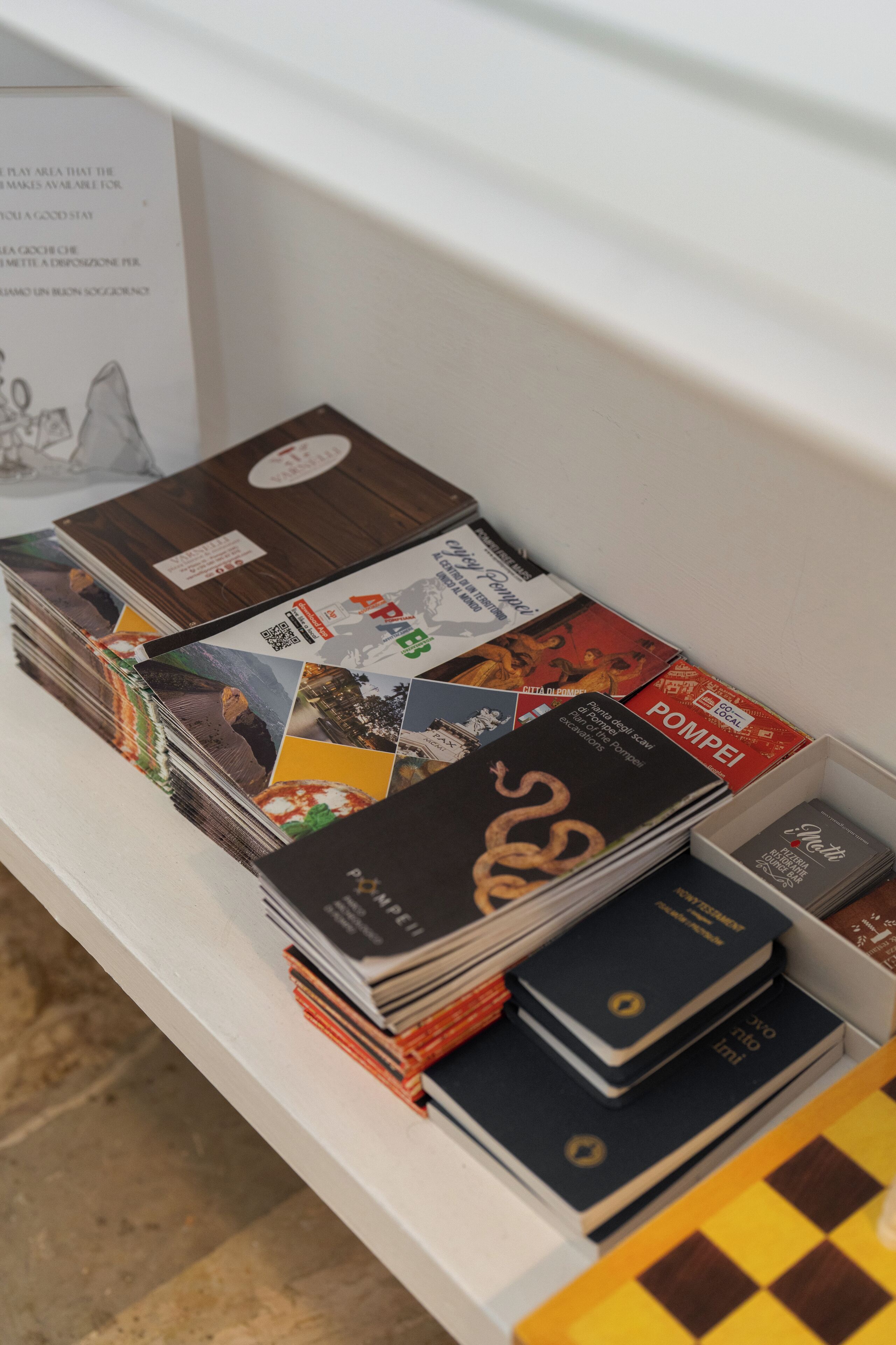 A display of books and magazines on a shelf.